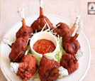 An enticing plate of meat skewers paired with a delicious sauce, exemplifying the culinary artistry of Indian and Nepali dishes.