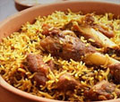 A delicious bowl of rice and meat with a fork, representing the best of Indian and Nepali culinary offerings.