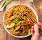 Colorful chicken and vegetable stir fry, showcasing the culinary excellence of a top Indian and Nepali restaurant.